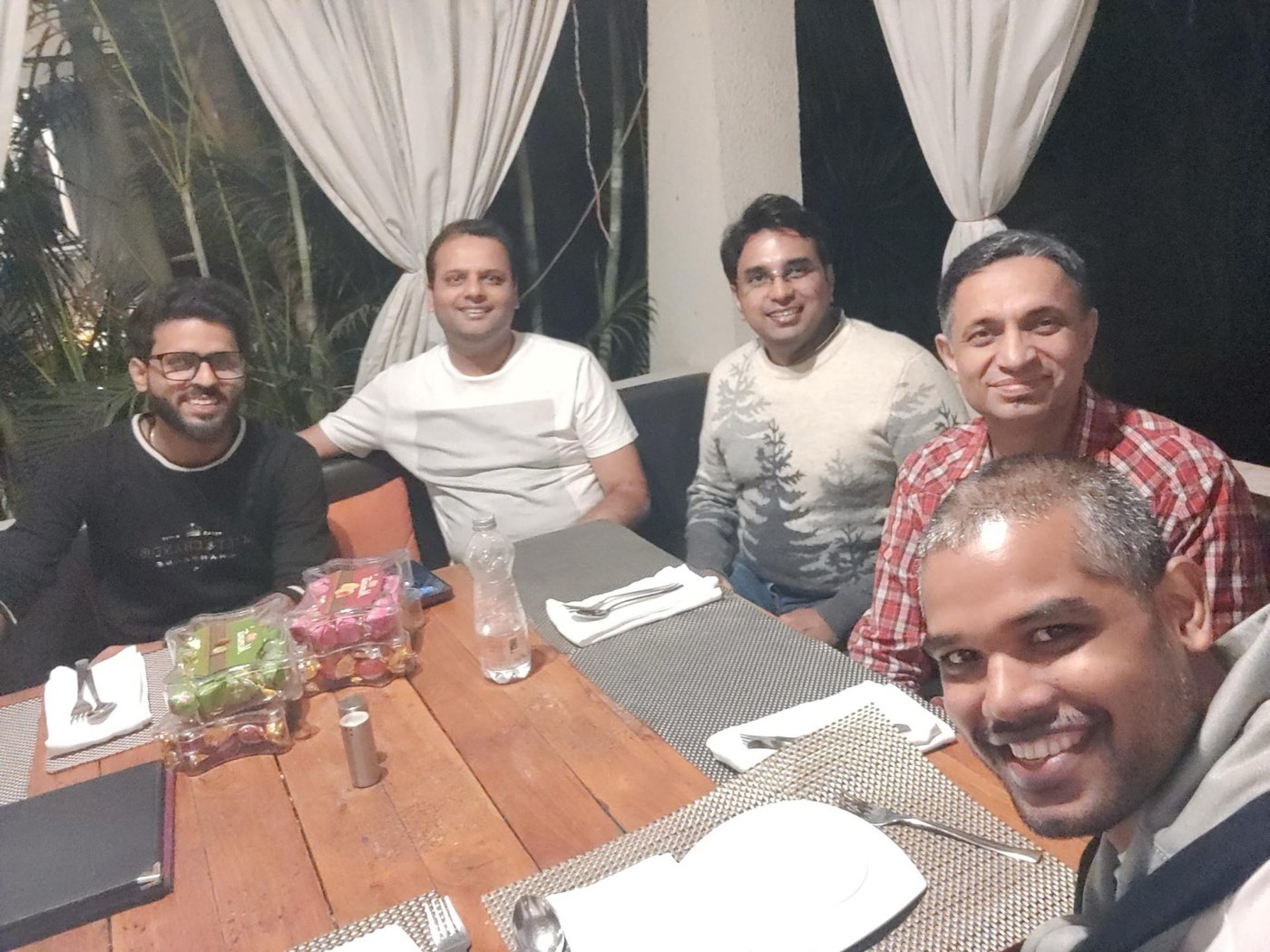 Next Quarter team sharing a meal around a table