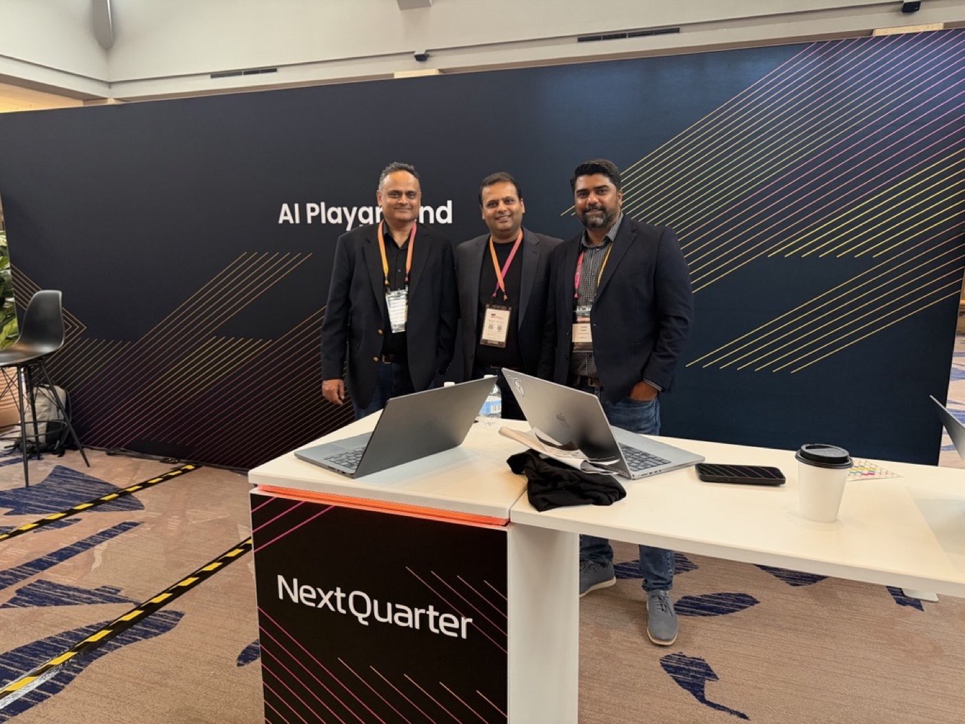 Next Quarter team at an AI conference booth